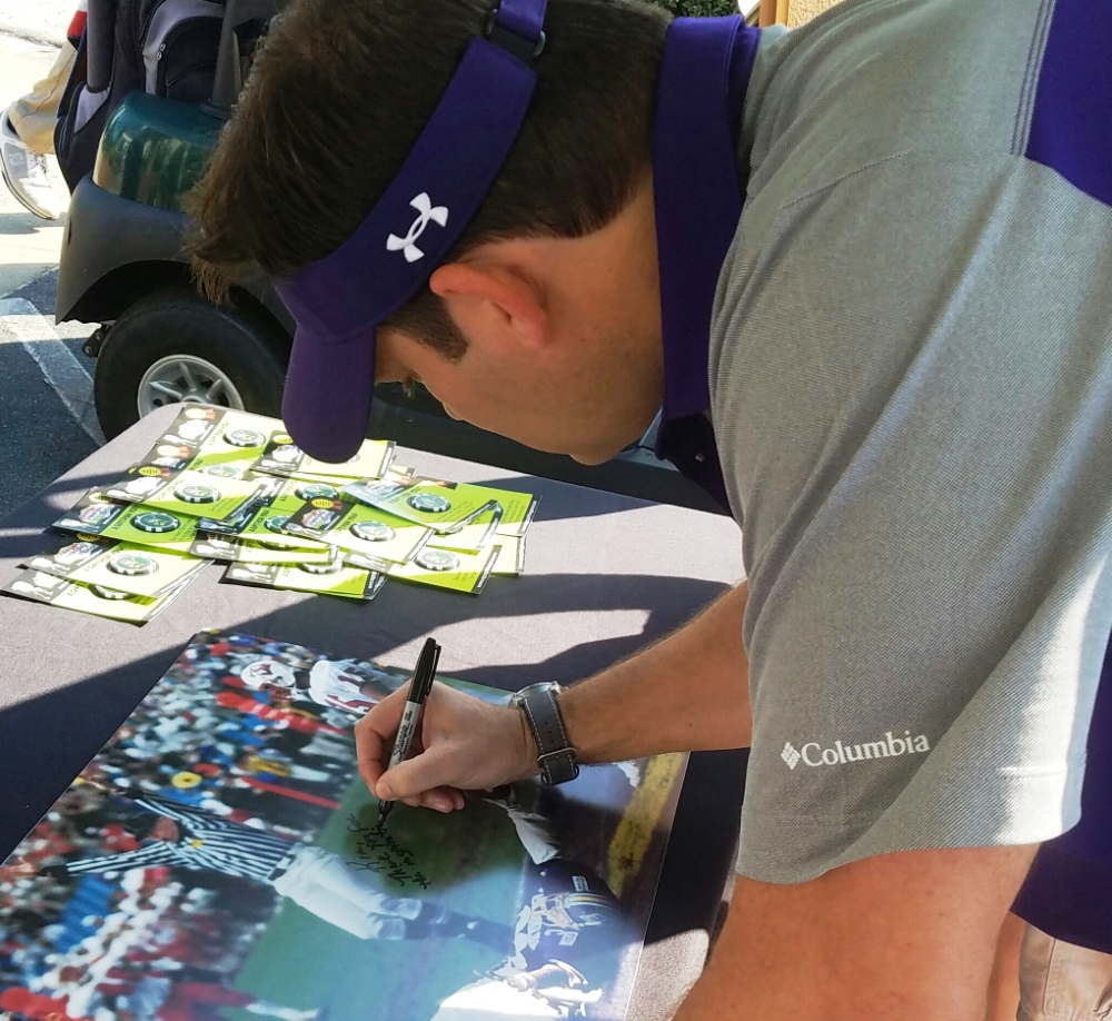Luke Fisher pens a very special autograph for Kim Reaves, wife of ECU coach's show photographer and producer Brian Meador. (Submitted photo)