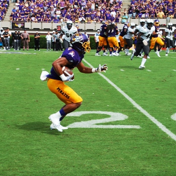 ECU's Quay Johnson looks for running room after a reception on the Pirates' first scoring drive. (Photo by Al Myatt)