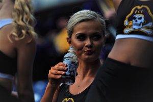 A member of the Solid Gold dance team stays hydrated during halftime