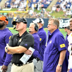 ECU coach Mike Houston watched action on the giant screen with Navy in the red zone