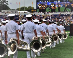 Navy brass of the present, and possibly the future, walks the sideline before their halftime presentation