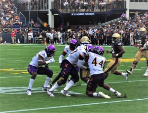 Navy's C.J. Williams runs into a host of Pirates in a 42-10 win for the Midshipmen
