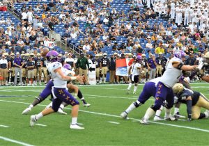 Sophomore quarterback Holton Ahlers passes for the Pirates against Navy