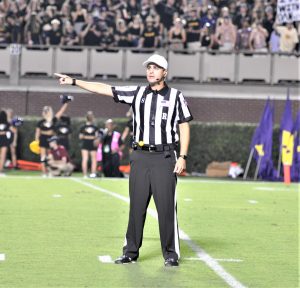 Referee Adam Savoie indicates a penalty against Temple. The Owls drew eight flags for 50 yards in the first half while ECU was not assessed a penalty in the opening 30 minutes. (Photo by Al Myatt)