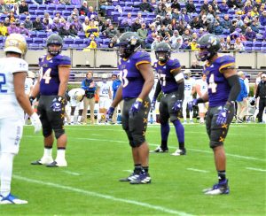 From left, senior defensive linemen Alex Turner, Jalen Price and Kendall Futrell played their last game for the Pirates. (Photo by Al Myatt)