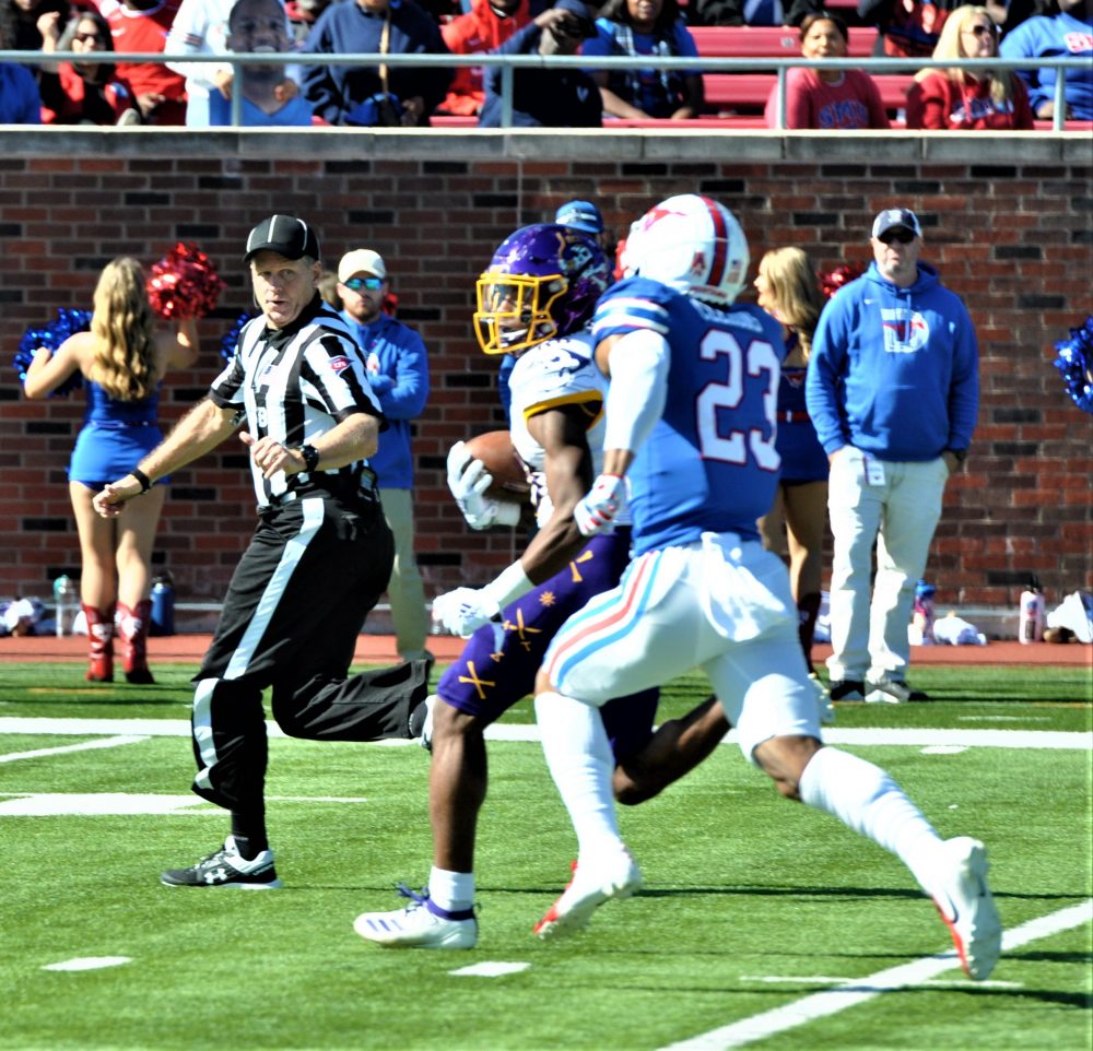 Jsi Hatfield of the Pirates has a step on an SMU defender en route to the end zone. (Photo by Al Myatt)