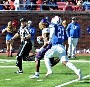 Jsi Hatfield of the Pirates has a step on an SMU defender en route to the end zone. (Photo by Al Myatt)