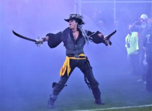 The Pirate emerges from the smoke before ECU takes the field (Al Myatt photo)
